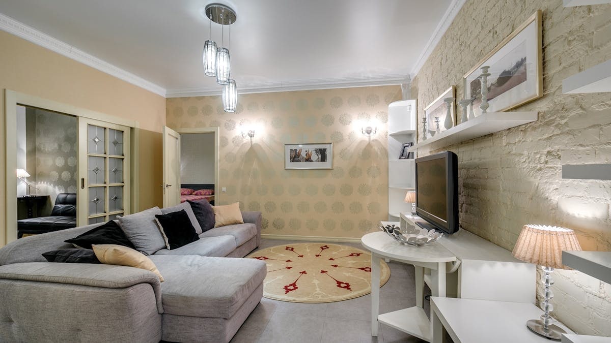 Elegant living room featuring modern decor, stylish lighting, and comfortable seating.